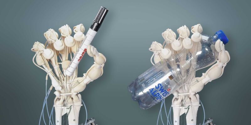 Robotic hands holding a marker and a water bottle